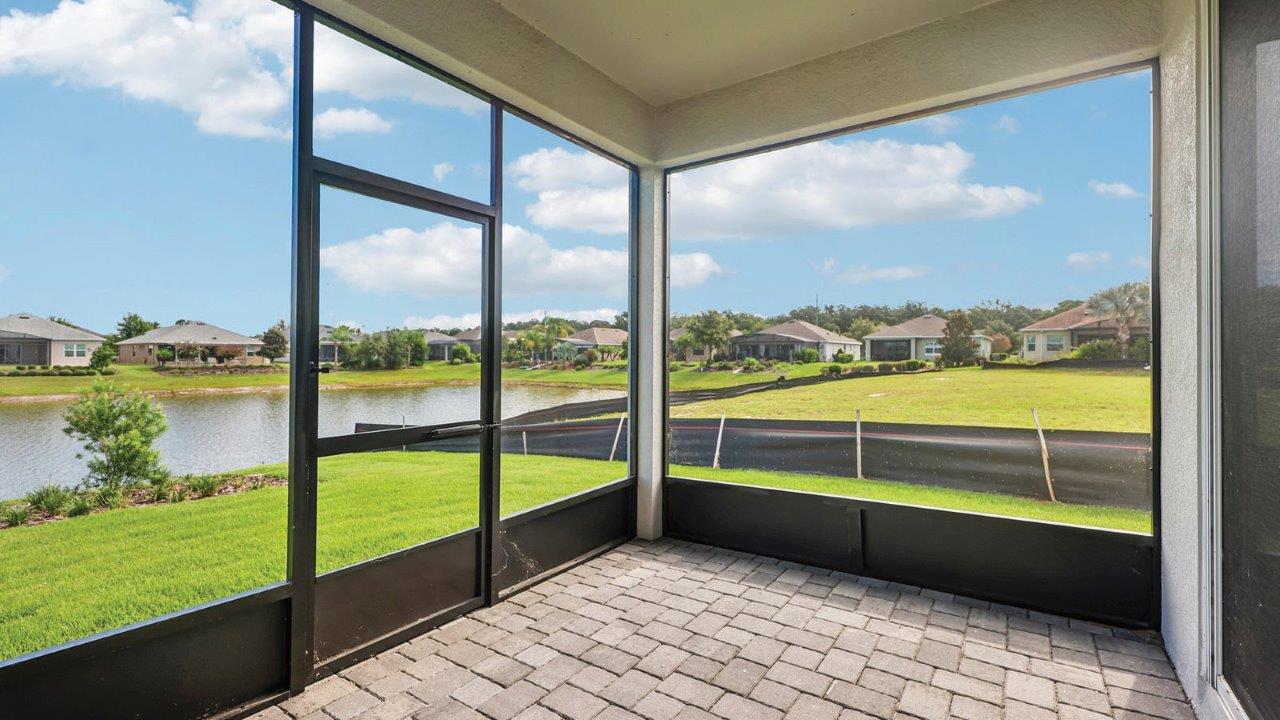 screened back lanai with pavers and a door