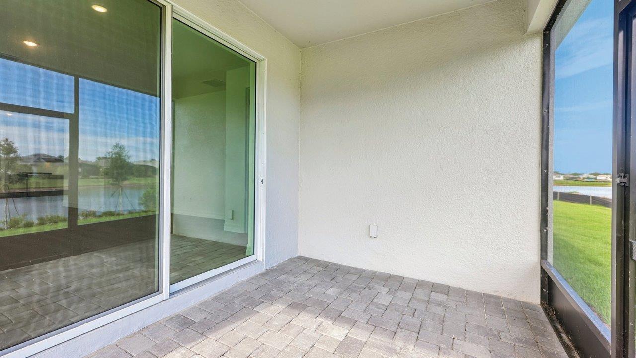 screened back lanai with pavers and a door