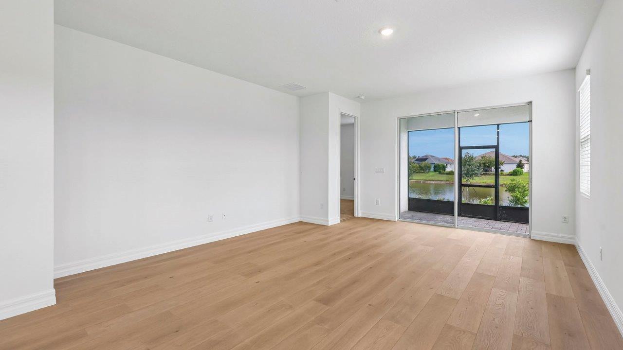Living room with sliding doors and entrance to primary bedroom