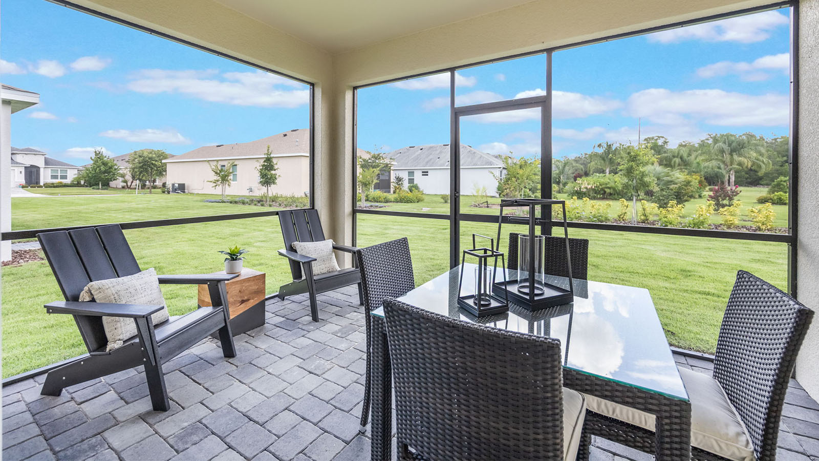 Screened back porch with table and chairs