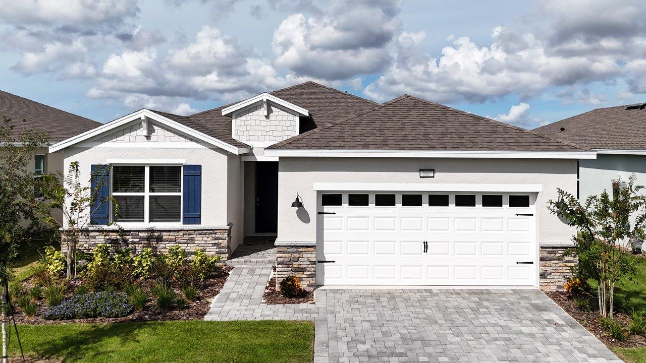 Exterior image of single-story home with 2 car garage and stone accents