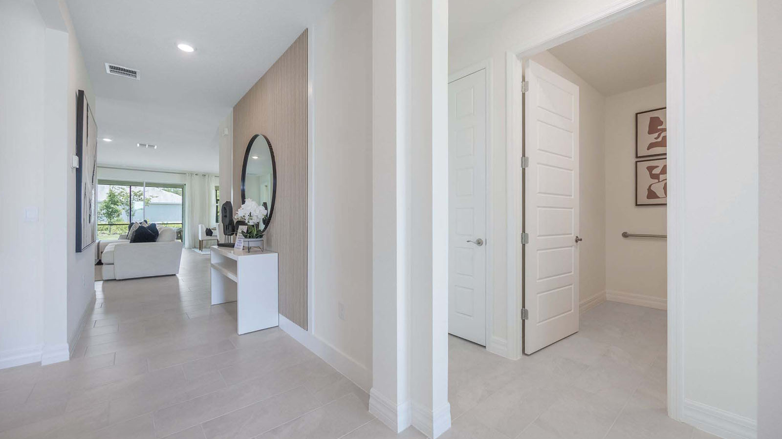 Entrance to the home with view to guest bathroom and additional bedrooms