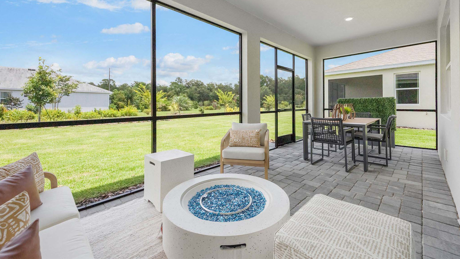 Screened in back porch with couch and table