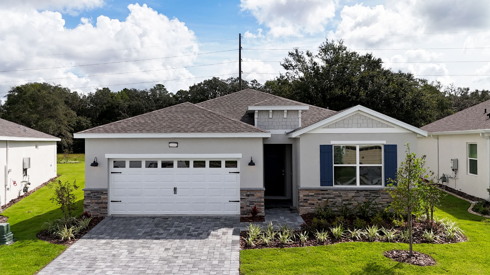 Exterior image of single-story home with 2 car garage and stone accents