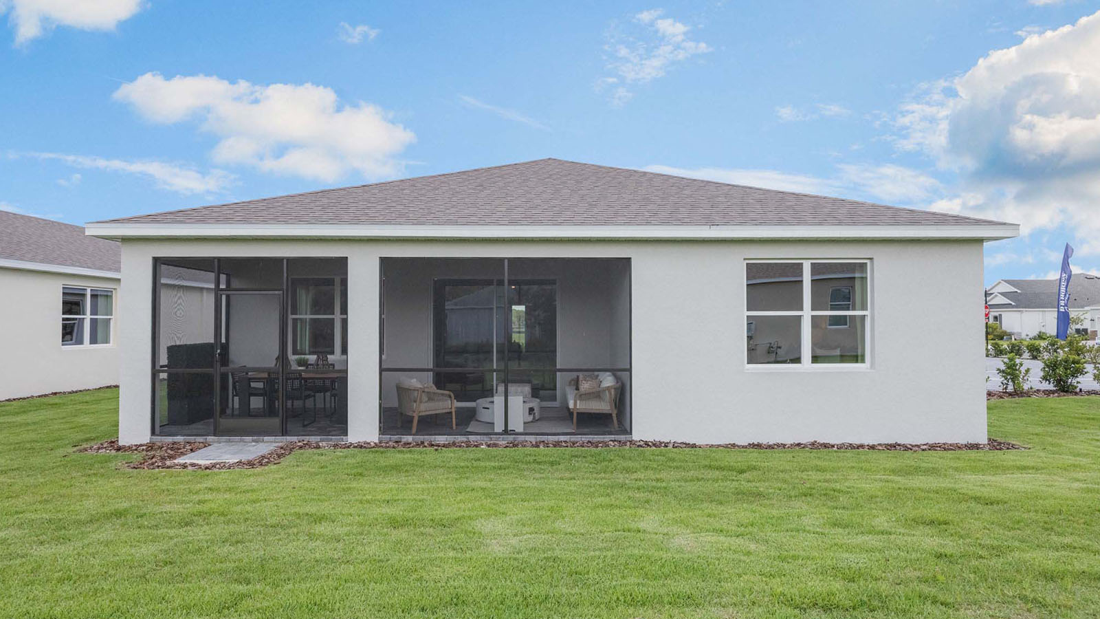 Rear elevation of single family home with screened in porch