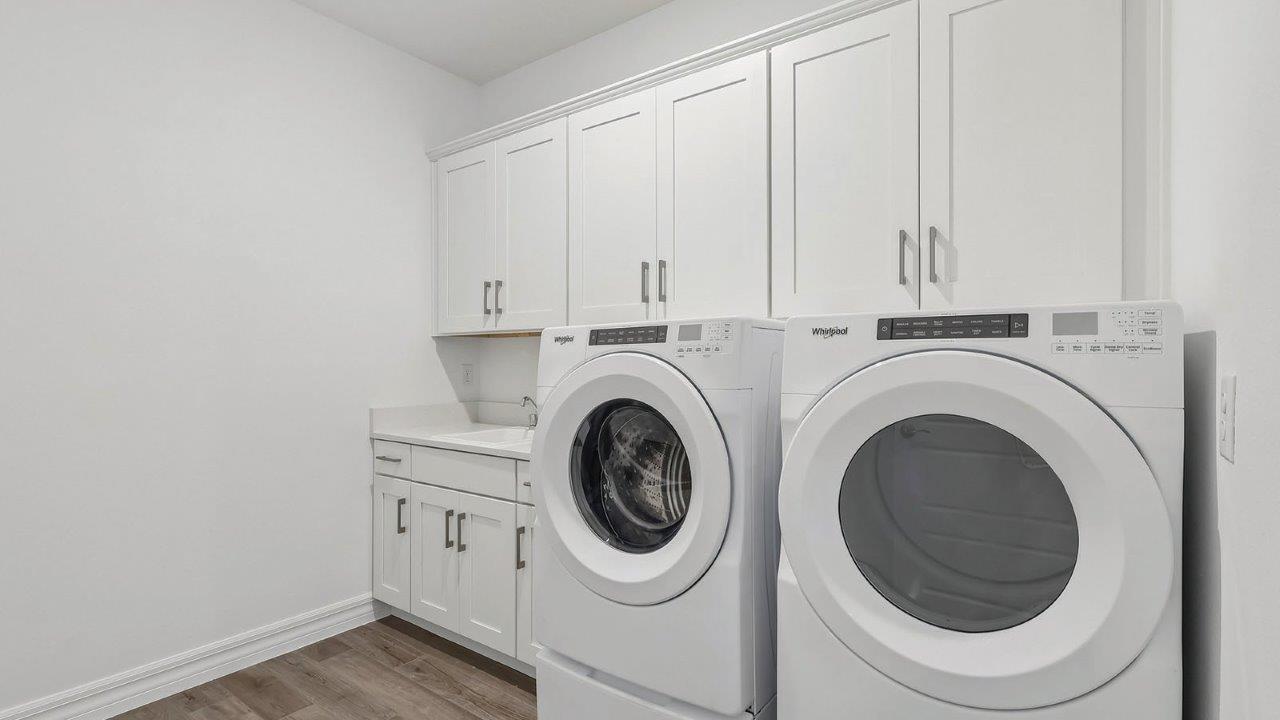 Laundry room with cabinets and washer and dryer
