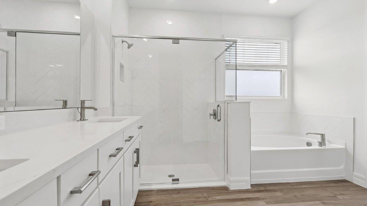primary bathroom with dual vanity sink
