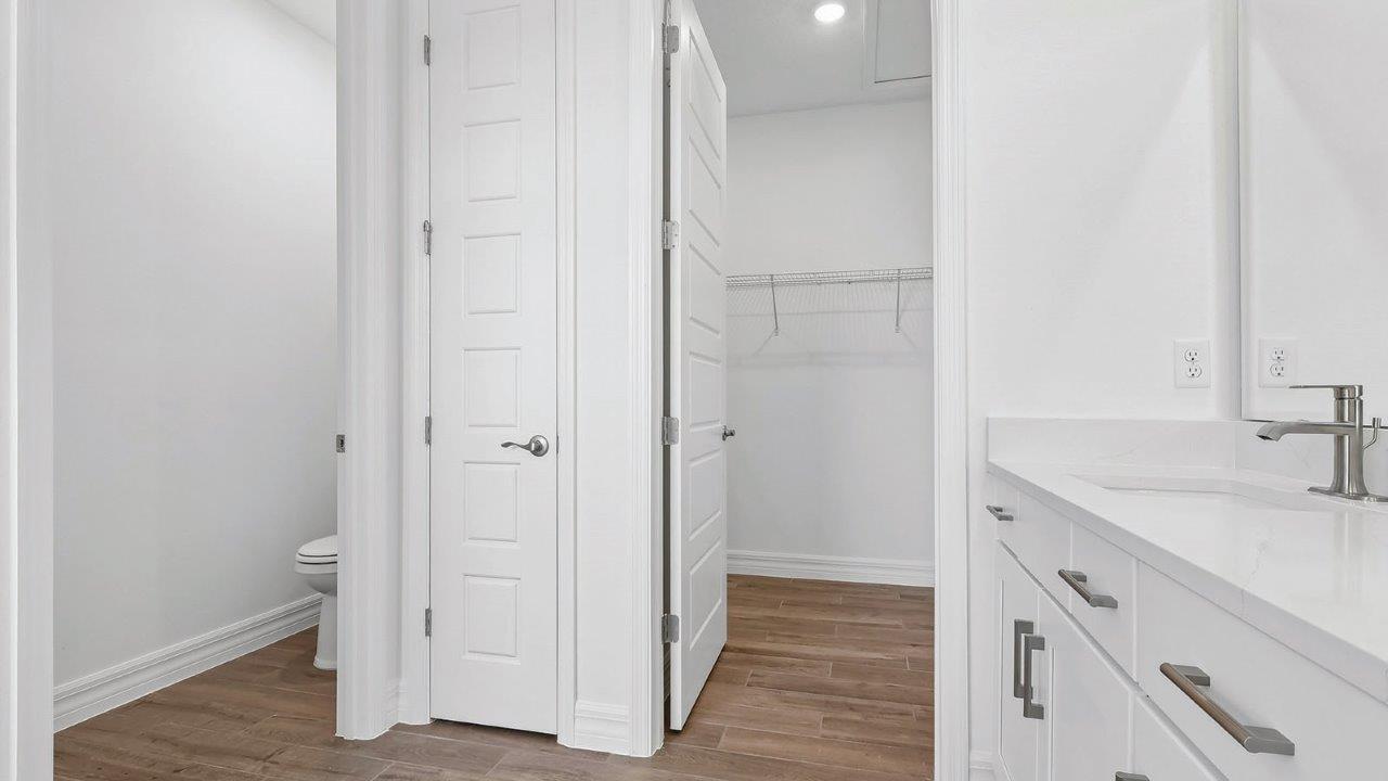 primary bathroom with walk in closet