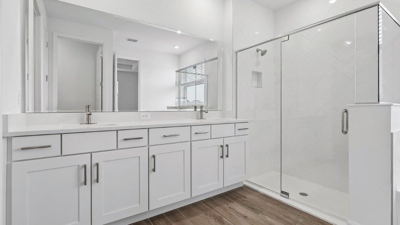 primary bathroom with dual vanity sink