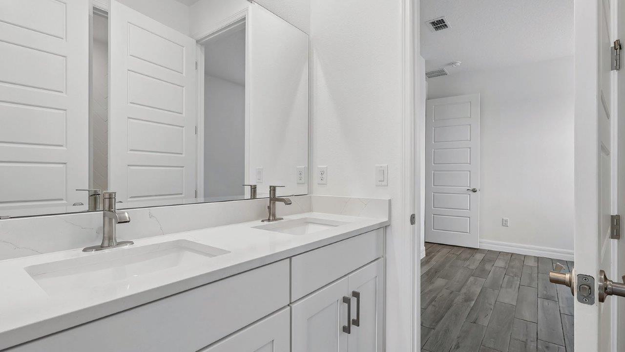 jack and jill bathroom with dual vanity sink