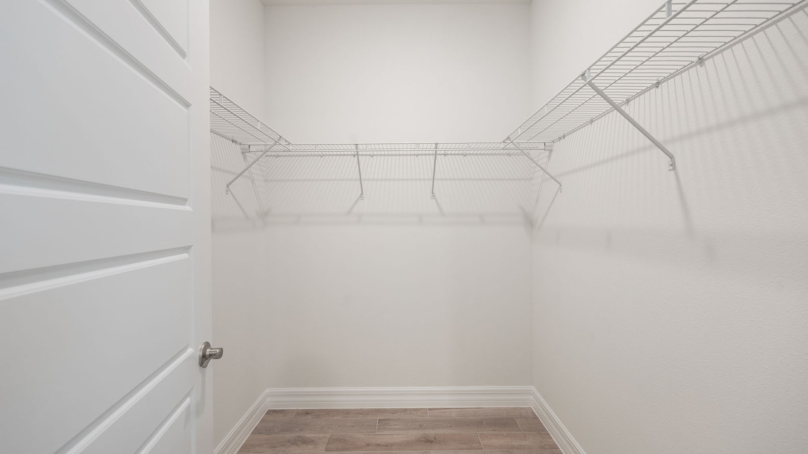 Primary bedroom walk in closet