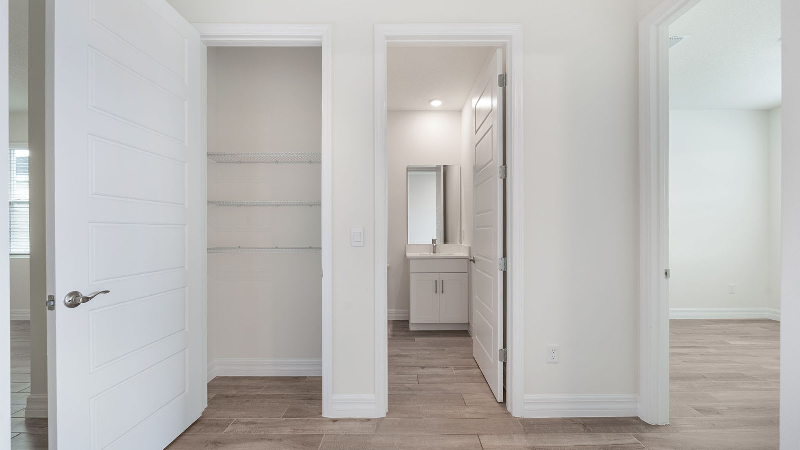 Hallway to guest bathroom with linen closet