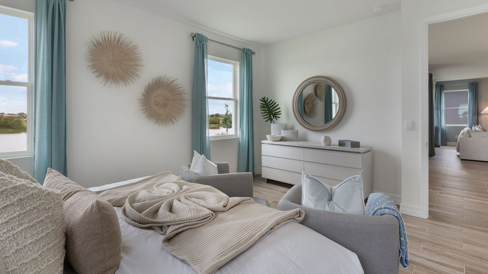 Primary bedroom with king size bed and dresser