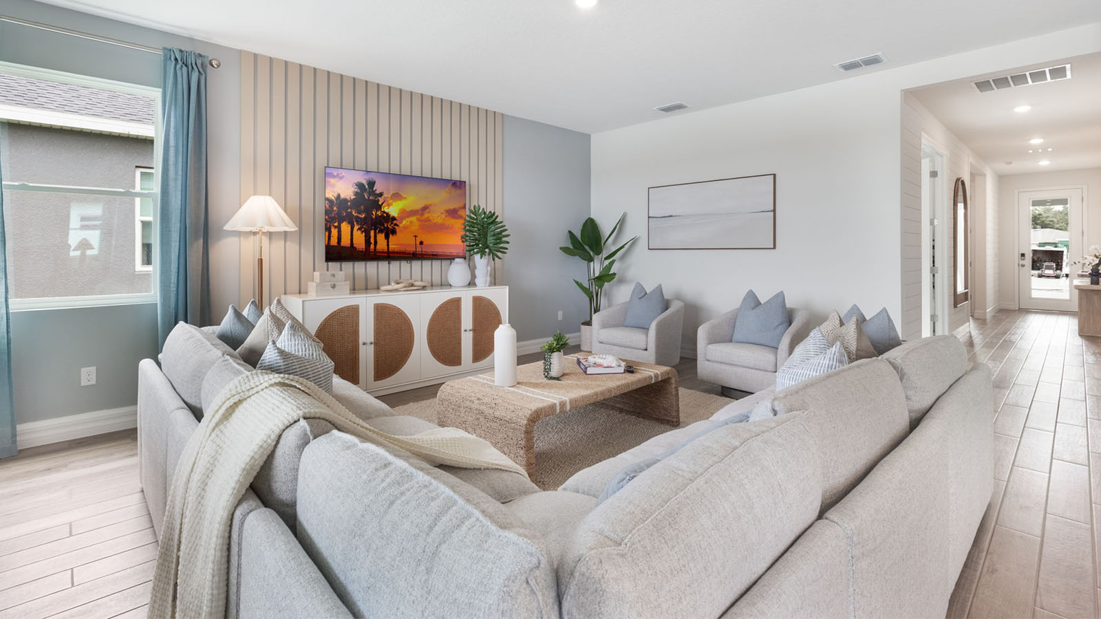 Spacious living room with large sectional and view to front door