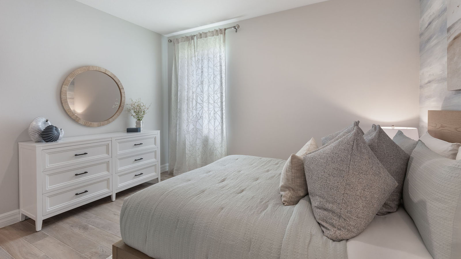 Spacious guest room with queen size bed and dresser
