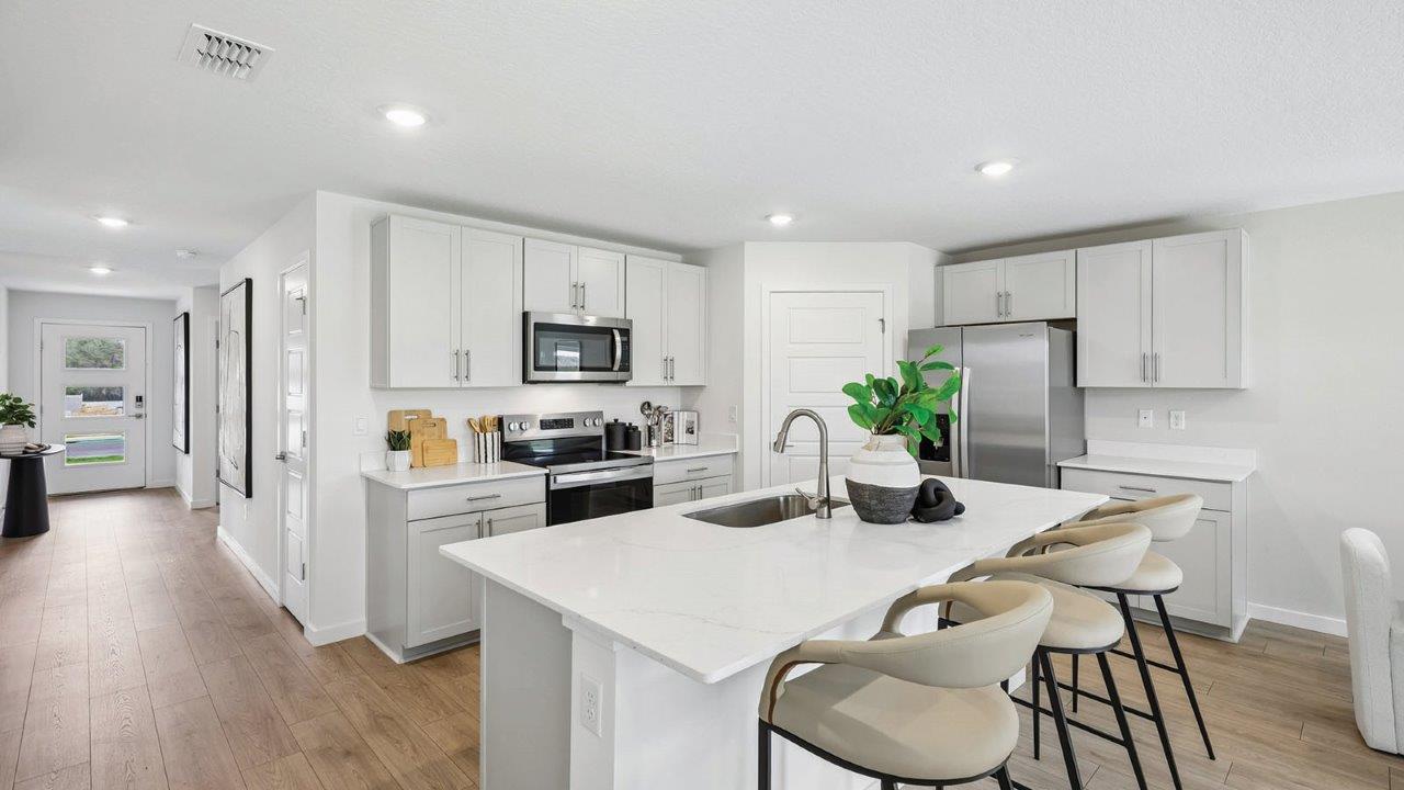 Kitchen with bar seating and entryway view