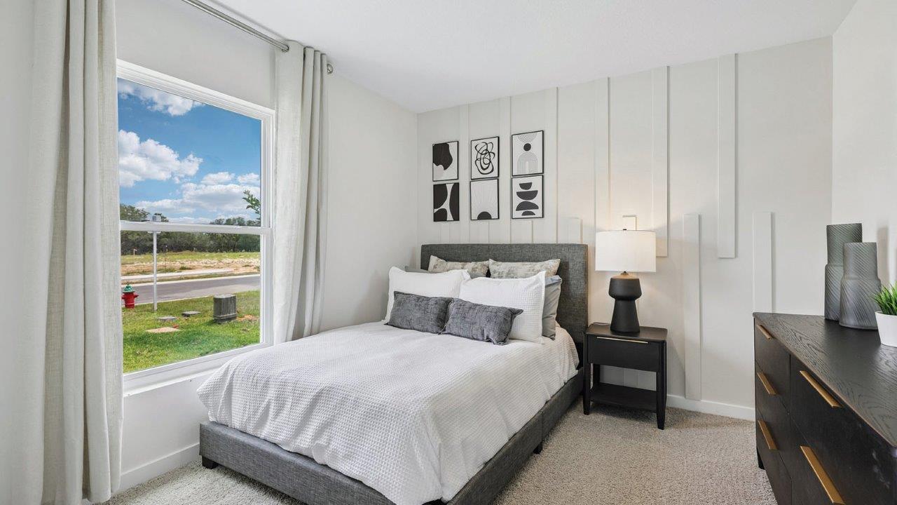 Guest bedroom with window and full size bed