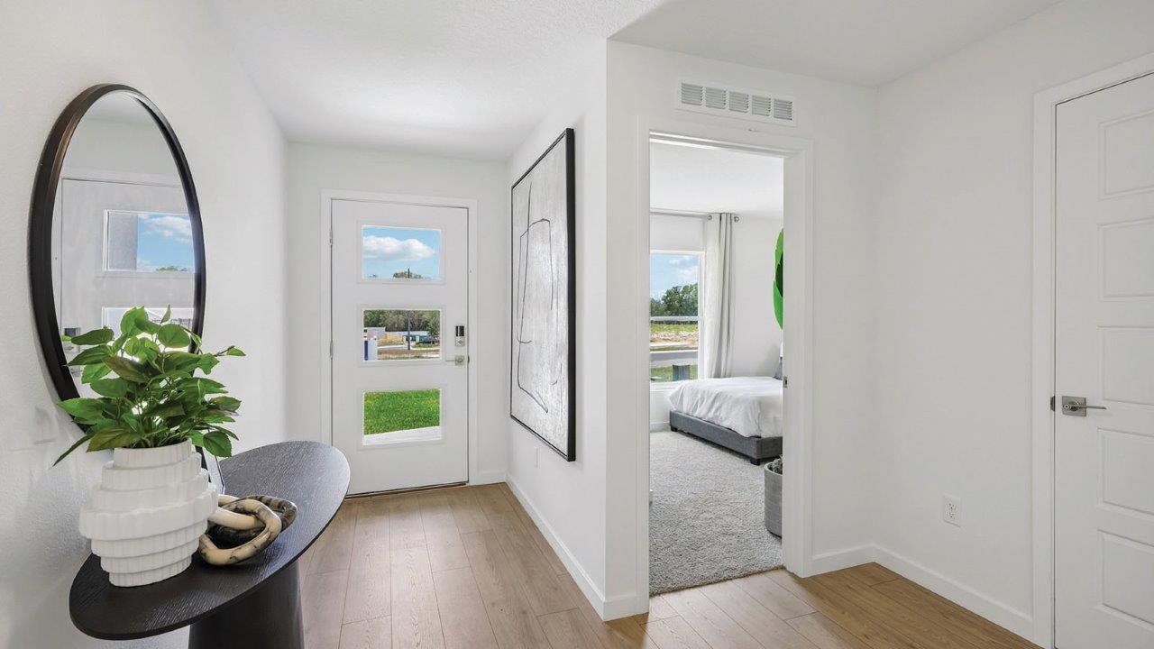 entryway with table and view of bedroom