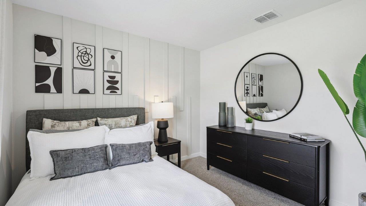 Guest room with full size bed and dresser