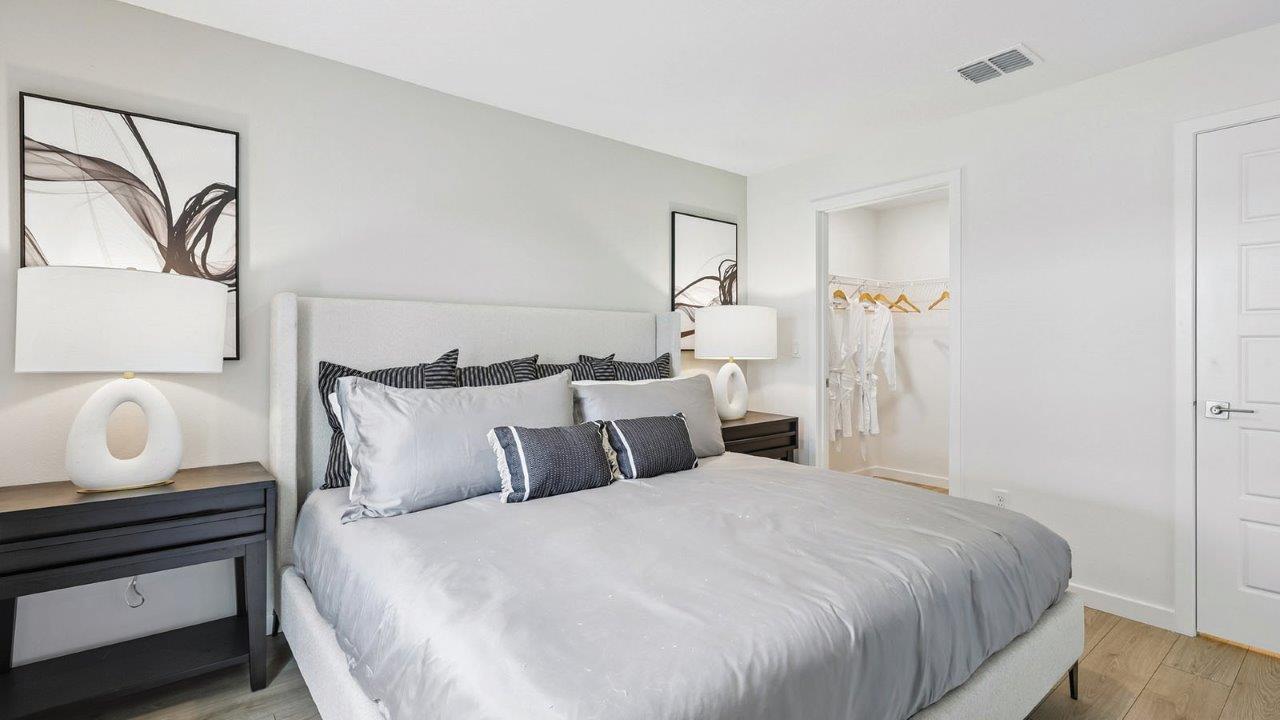 Primary bedroom with king size bed and walk in closet