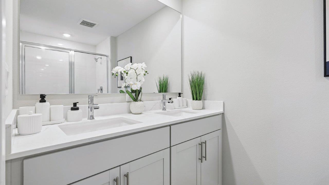 Primary bedroom ensuite bathroom with dual vanity sinks