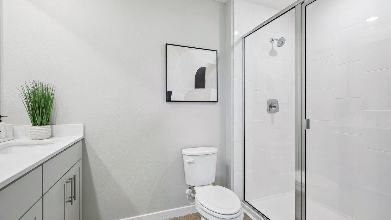 Primary bathroom with walk in shower and dual vanity sinks