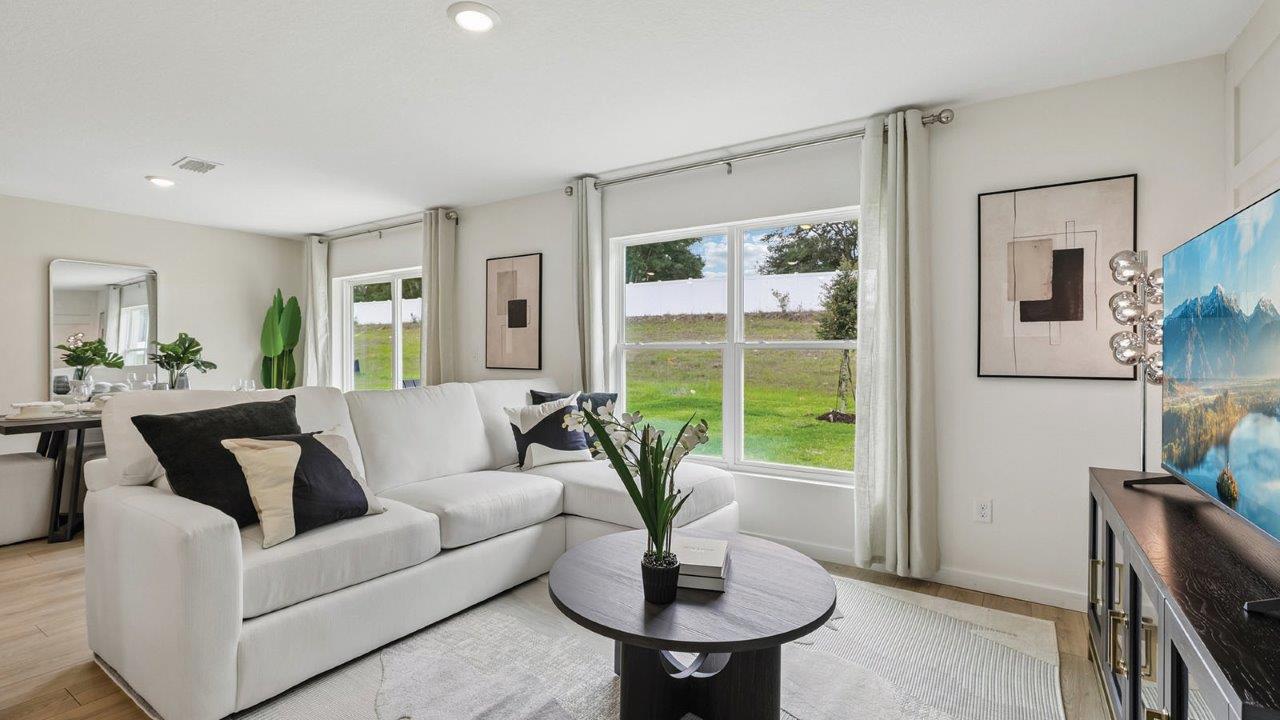 Living room with sectional and dining room view