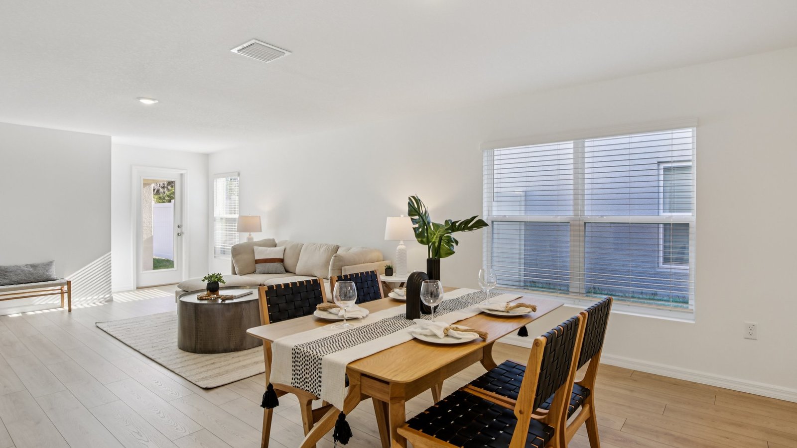 Dining room adjacent to the kitchen with table, chairs and LVP flooring.