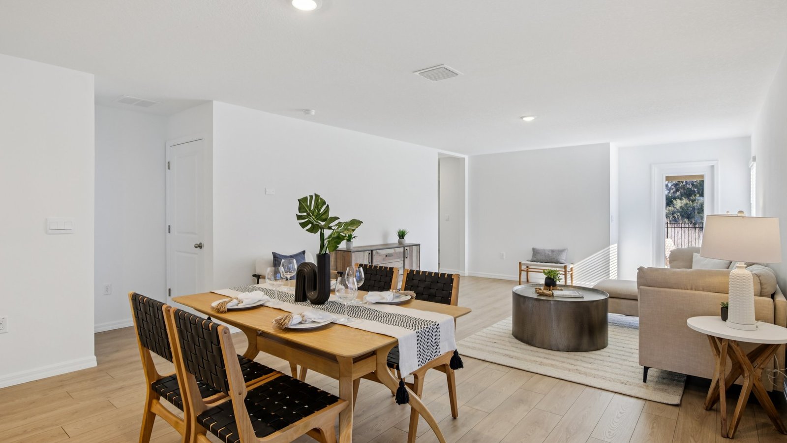 Dining room adjacent to the kitchen with table, chairs and LVP flooring.