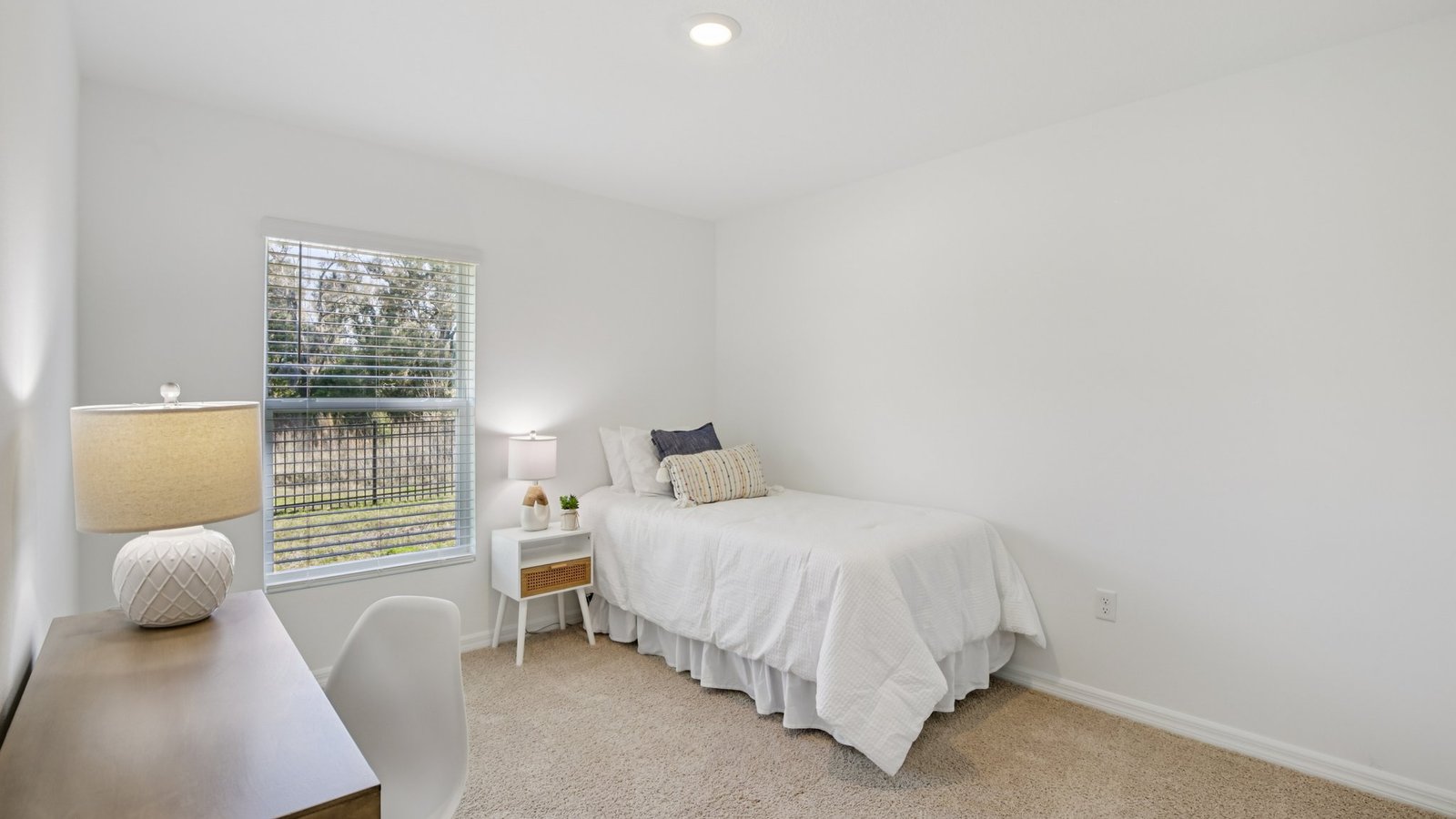Spare bedroom for guests, with bed, dresser, and ample closet storage.