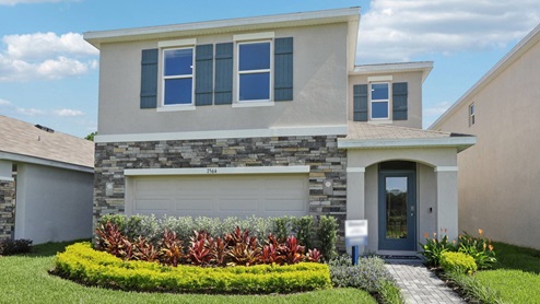 Two-story new home with stucco, covered porch and 2 car garage.New construction land O Lakes.