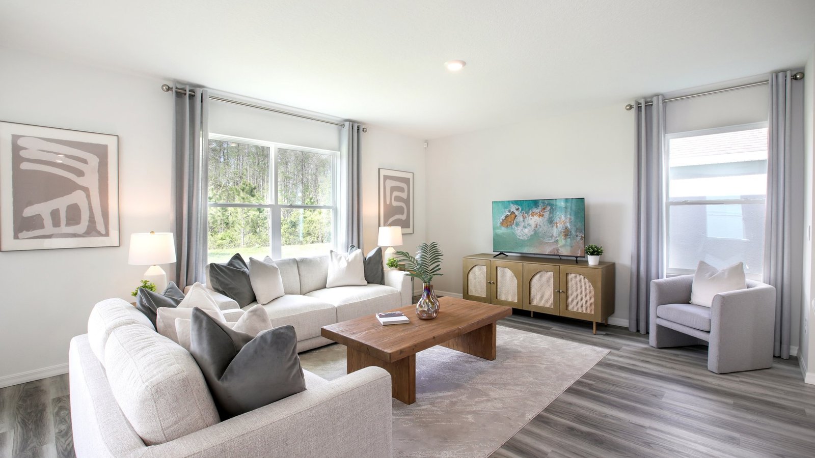 Open concept living area with couch seating and access to the backyard thru slider door.