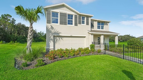 Two-story new home with stucco, covered porch and 2 car garage. New construction land O Lakes.