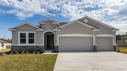 Single story new home with stucco, covered porch and 2 car garage. New construction land O Lakes.