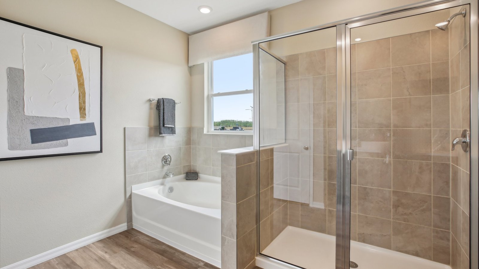 Modern bathroom with double vanity sinks, large wall mirror, cabinets and quartz countertops.