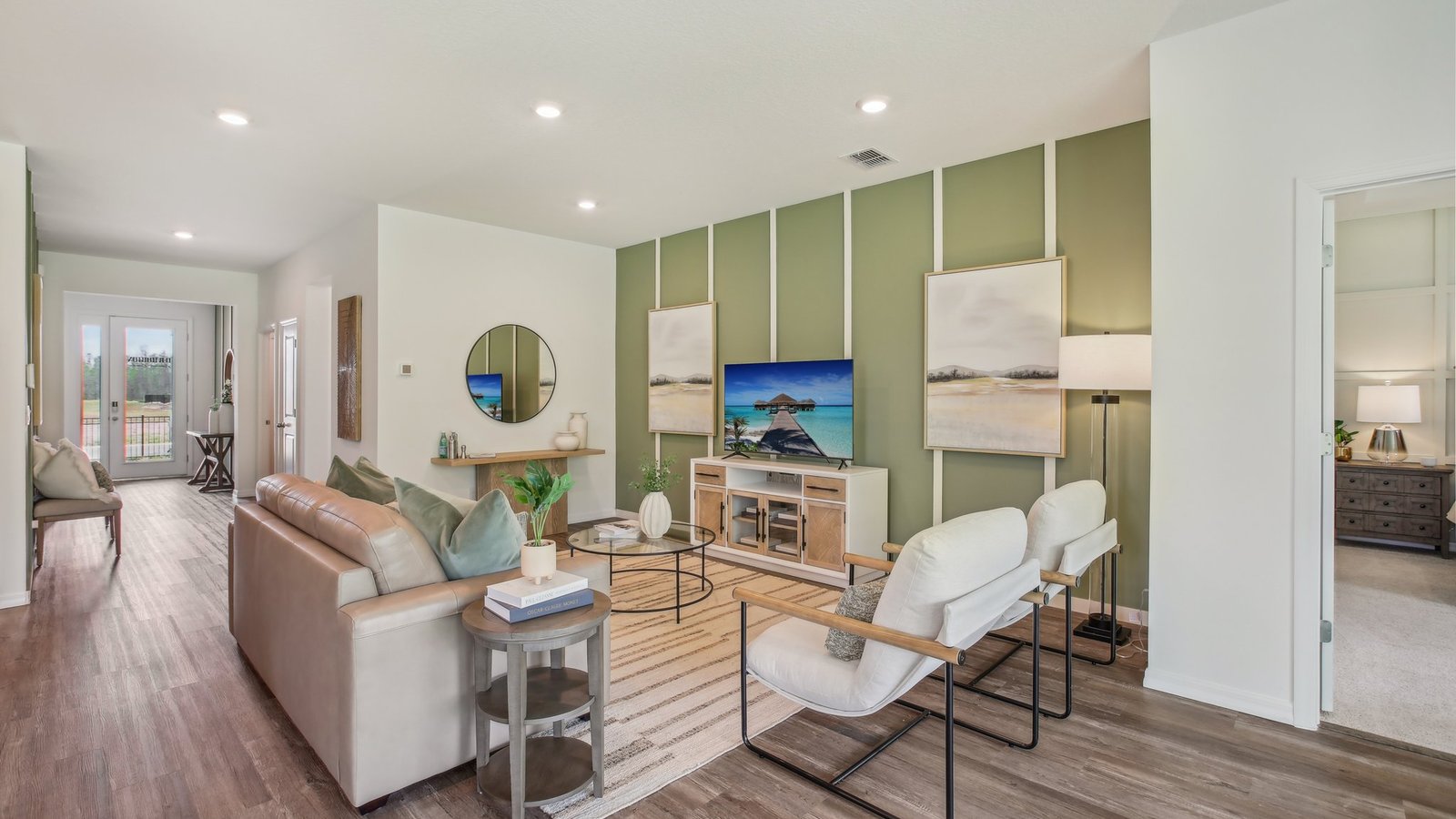 Kitchen with island seating, quartz counters, spacious pantry and stainless-steel appliances.
