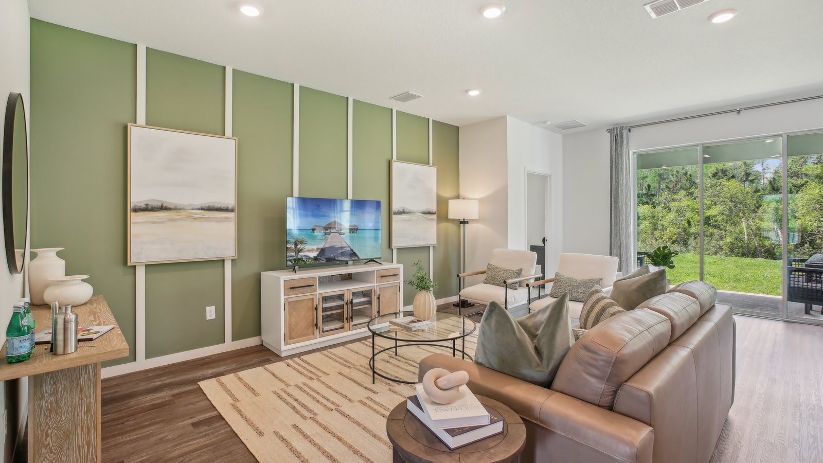 Open concept living area with couch seating and access to the backyard thru slider door.