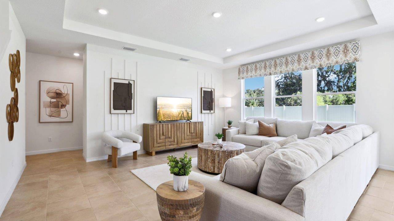 Open concept living area with couch seating and access to the backyard thru slider door.