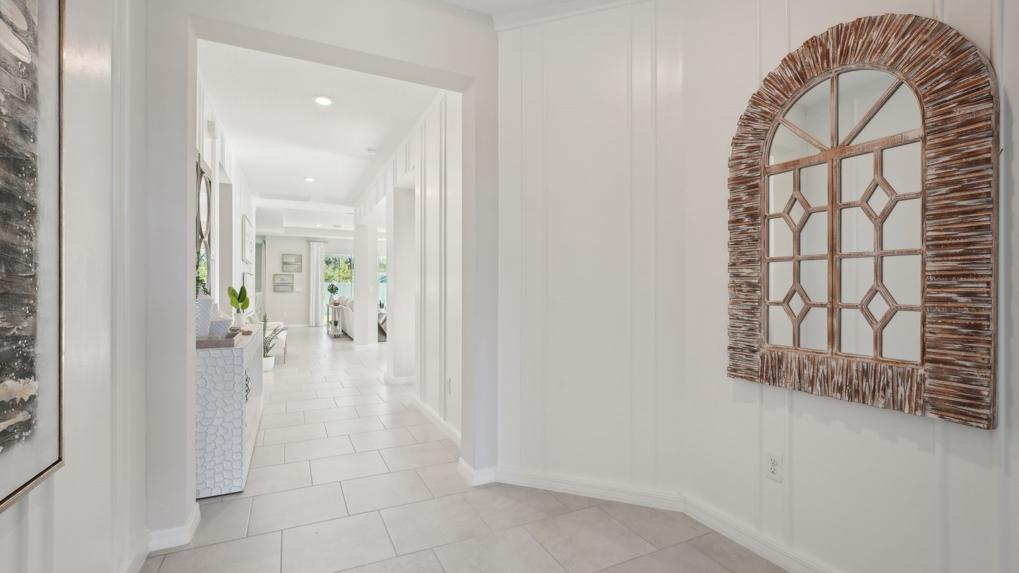 Home entry way thru the front door with tile flooring and a view to the living space.