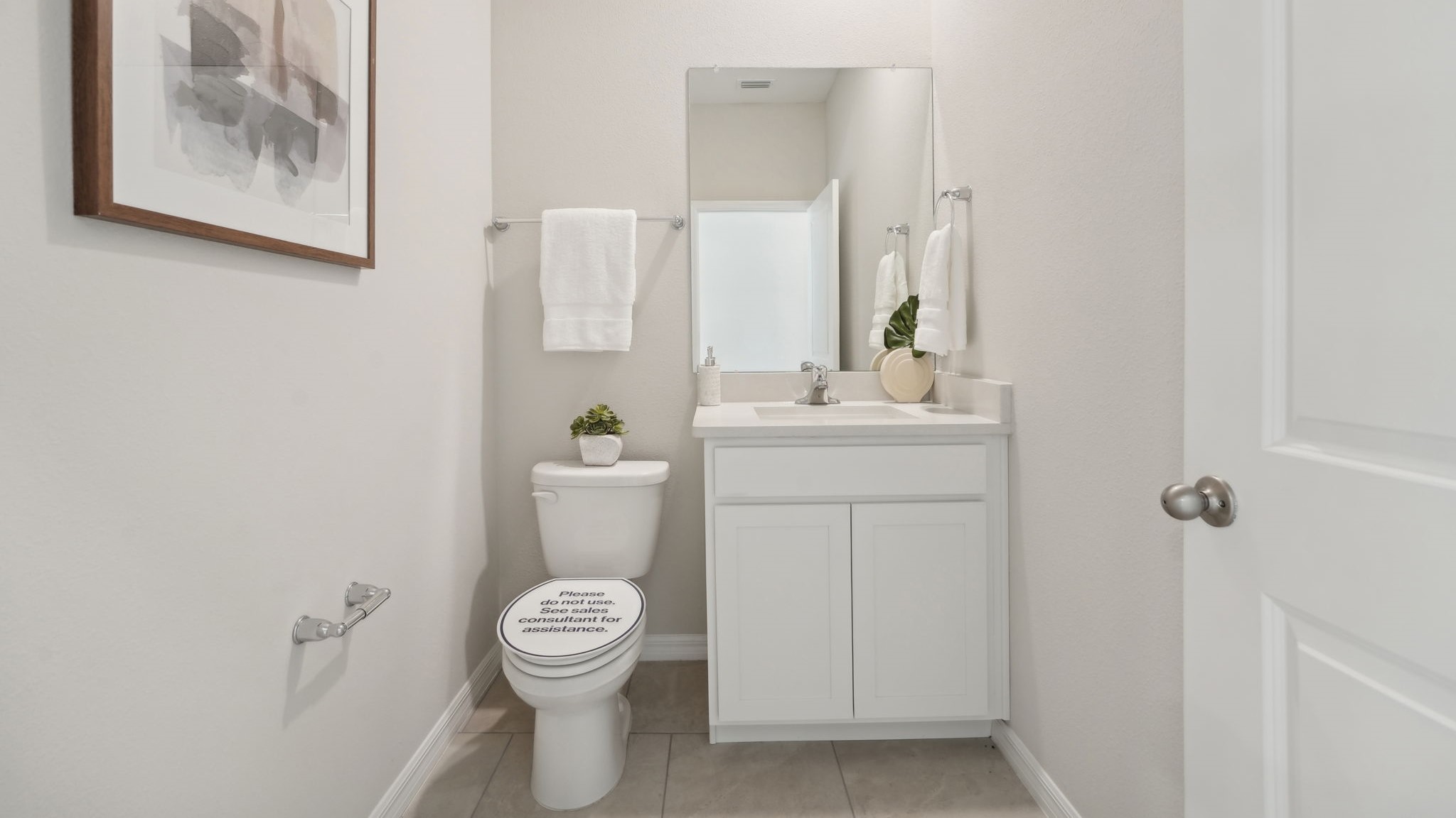 Modern bathroom with vanity sink, large wall mirror, and shower.