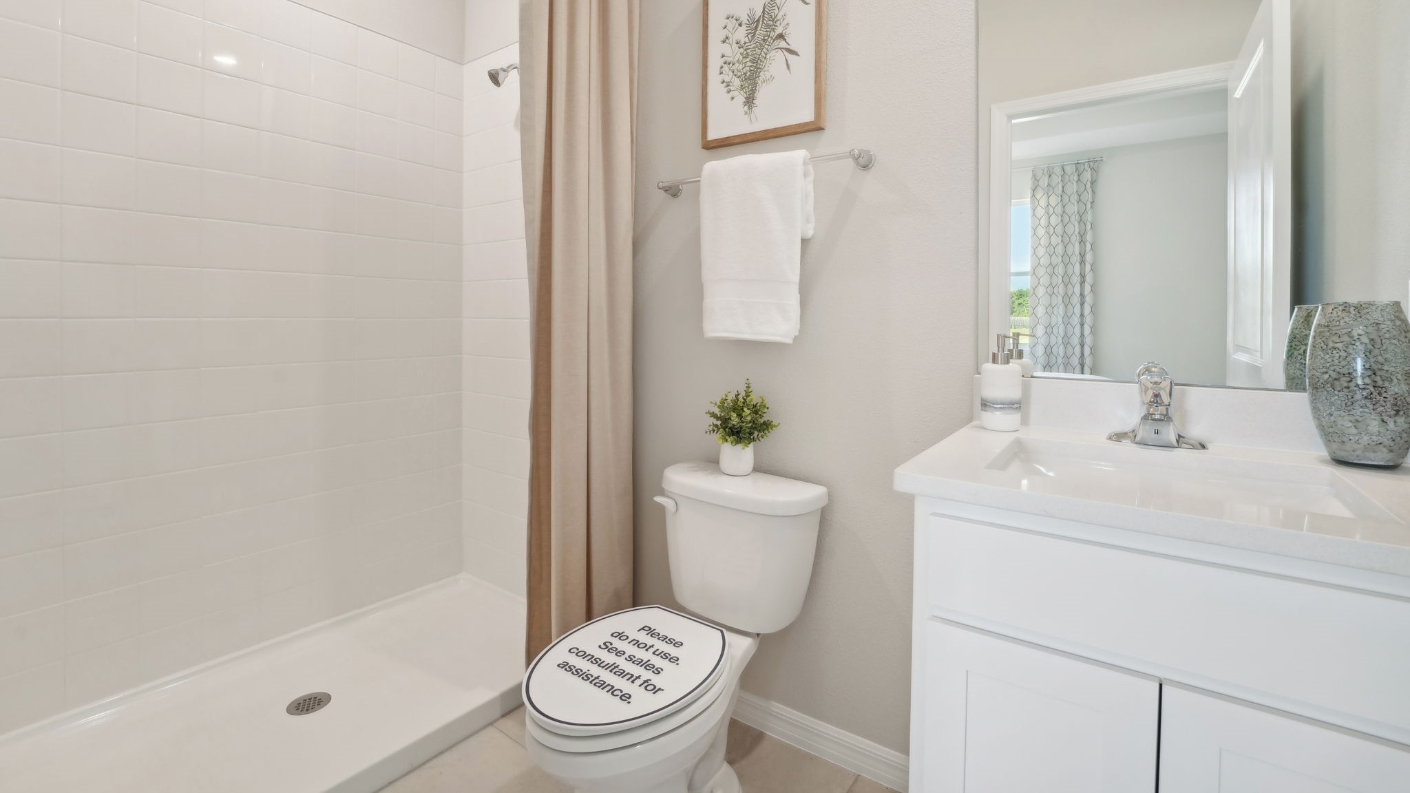Modern bathroom with vanity sink, large wall mirror, and shower.