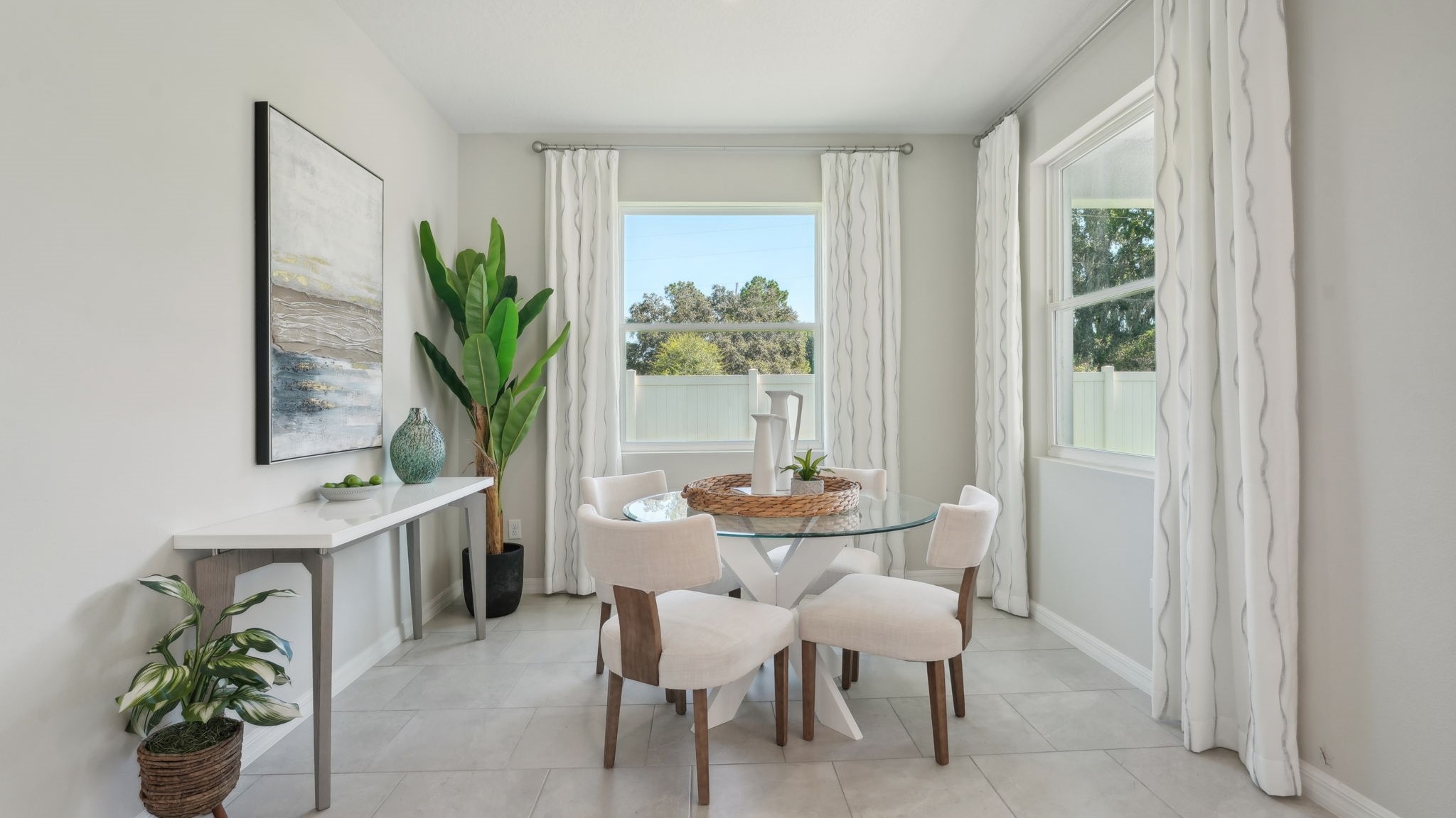 Kitchen with island seating, quartz counters, spacious pantry and stainless-steel appliances.