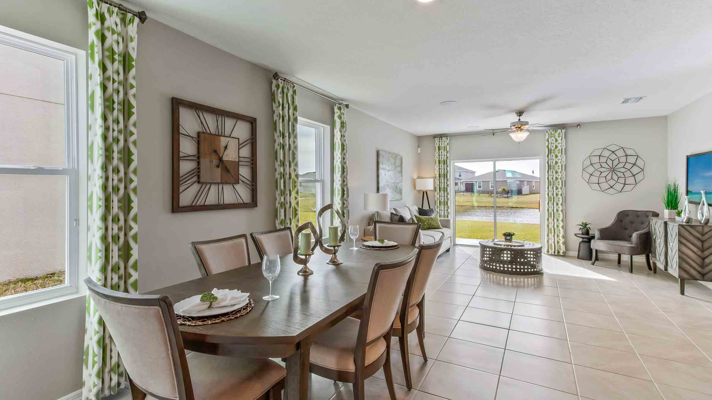 Dining room adjacent to the kitchen with table, chairs and tile flooring.