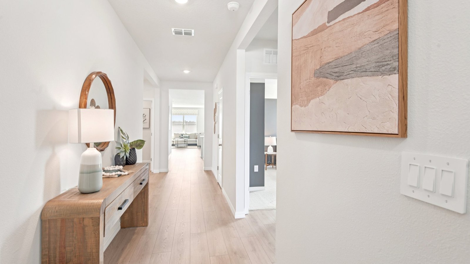 Home entry way thru the front door with LVP flooring and a view to the living space.