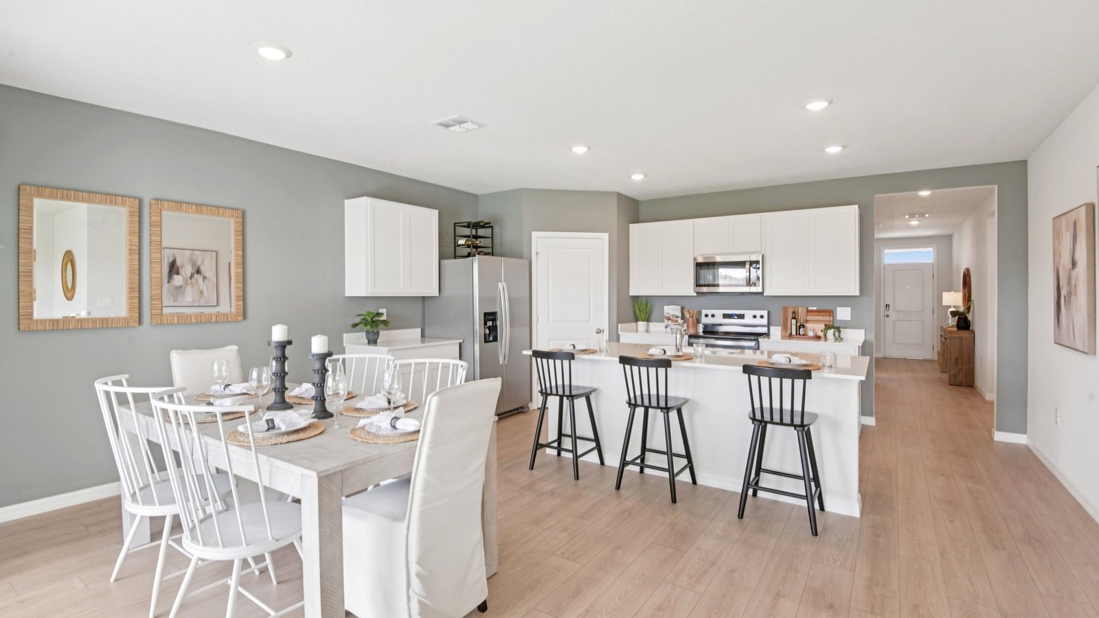 Dining room adjacent to the kitchen with table, chairs and LVP flooring.