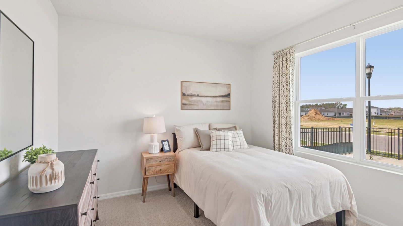 Guest bedroom with bed, nightstands and a roomy closet for storage.