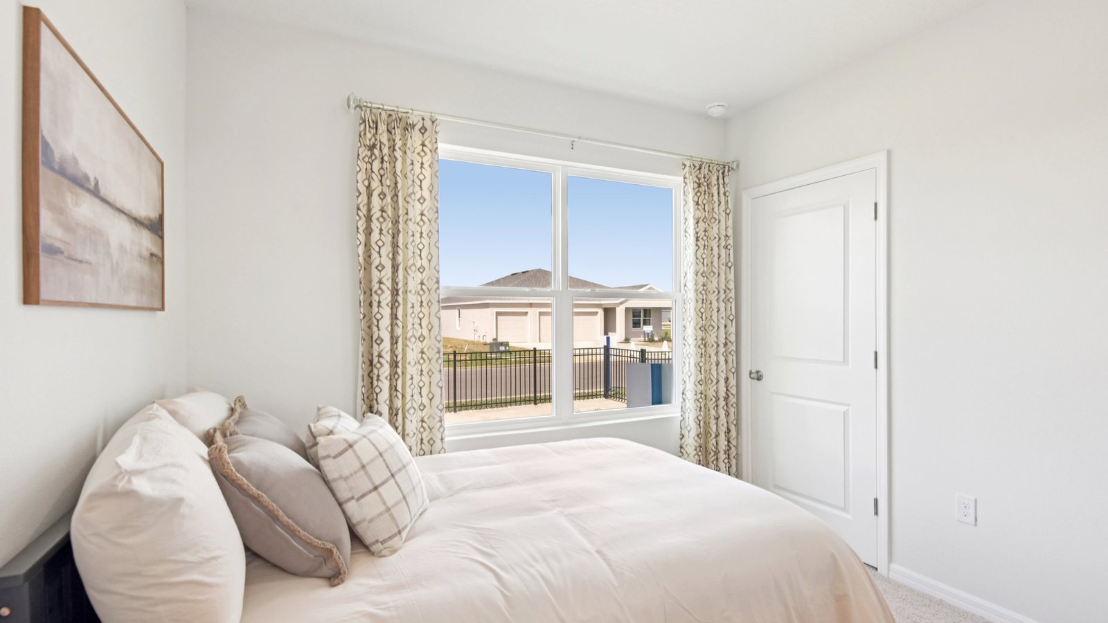 Guest bedroom with bed, nightstands and a roomy closet for storage.