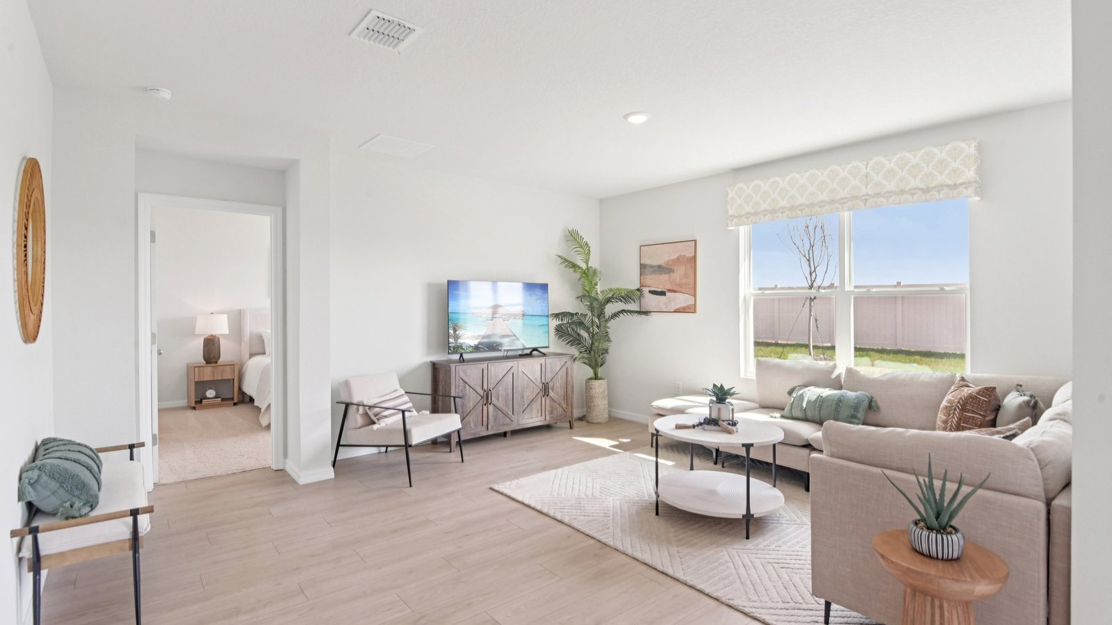 Open concept living area with couch seating and access to the backyard thru slider door.
