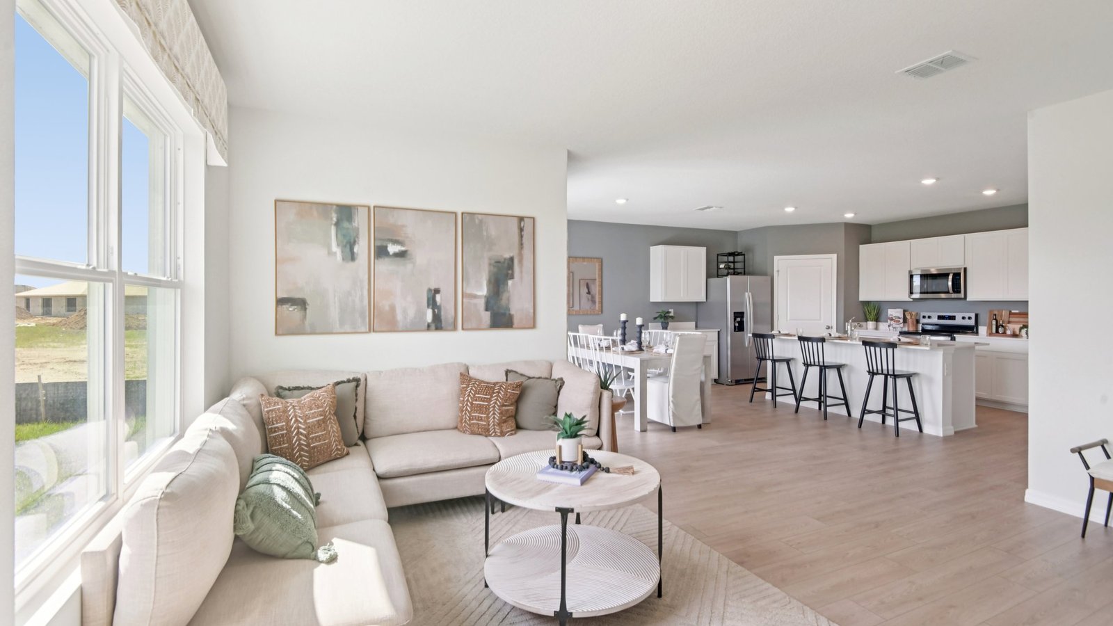 Open concept living area with couch seating and access to the backyard thru slider door.