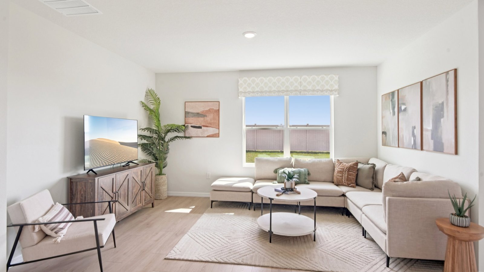 Open concept living area with couch seating and access to the backyard thru slider door.
